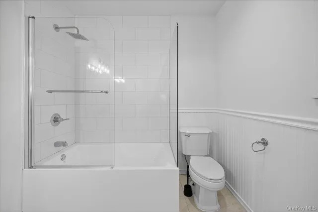 an empty room with windows and ceiling fan