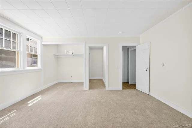 a view of a livingroom with wooden floor and a flat screen tv