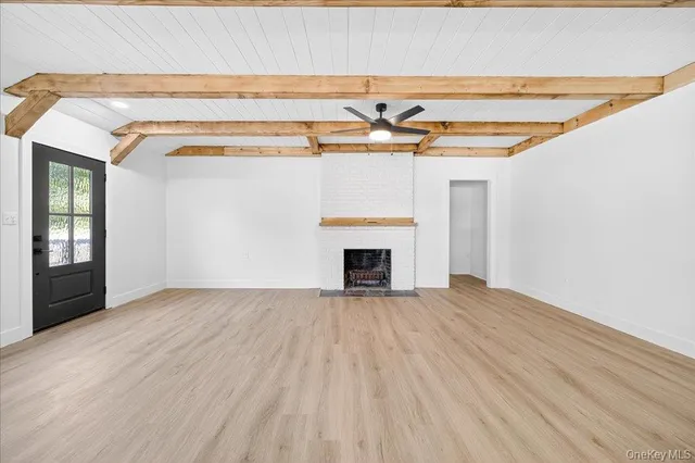 a kitchen with stainless steel appliances granite countertop a stove a sink dishwasher and a refrigerator with wooden floor