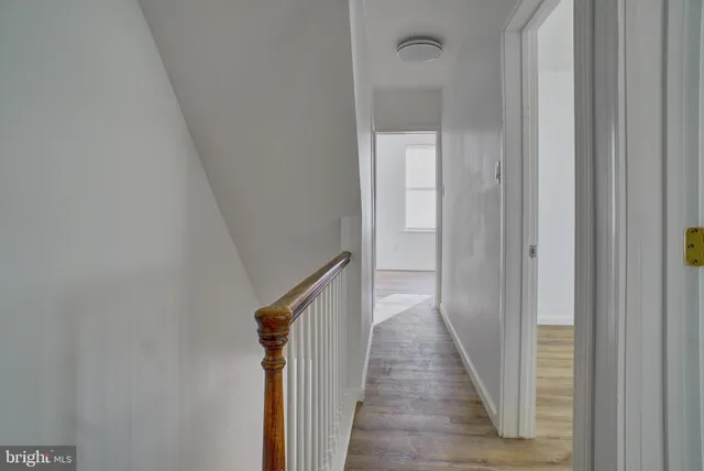 a view of a hallway with a wooden floor
