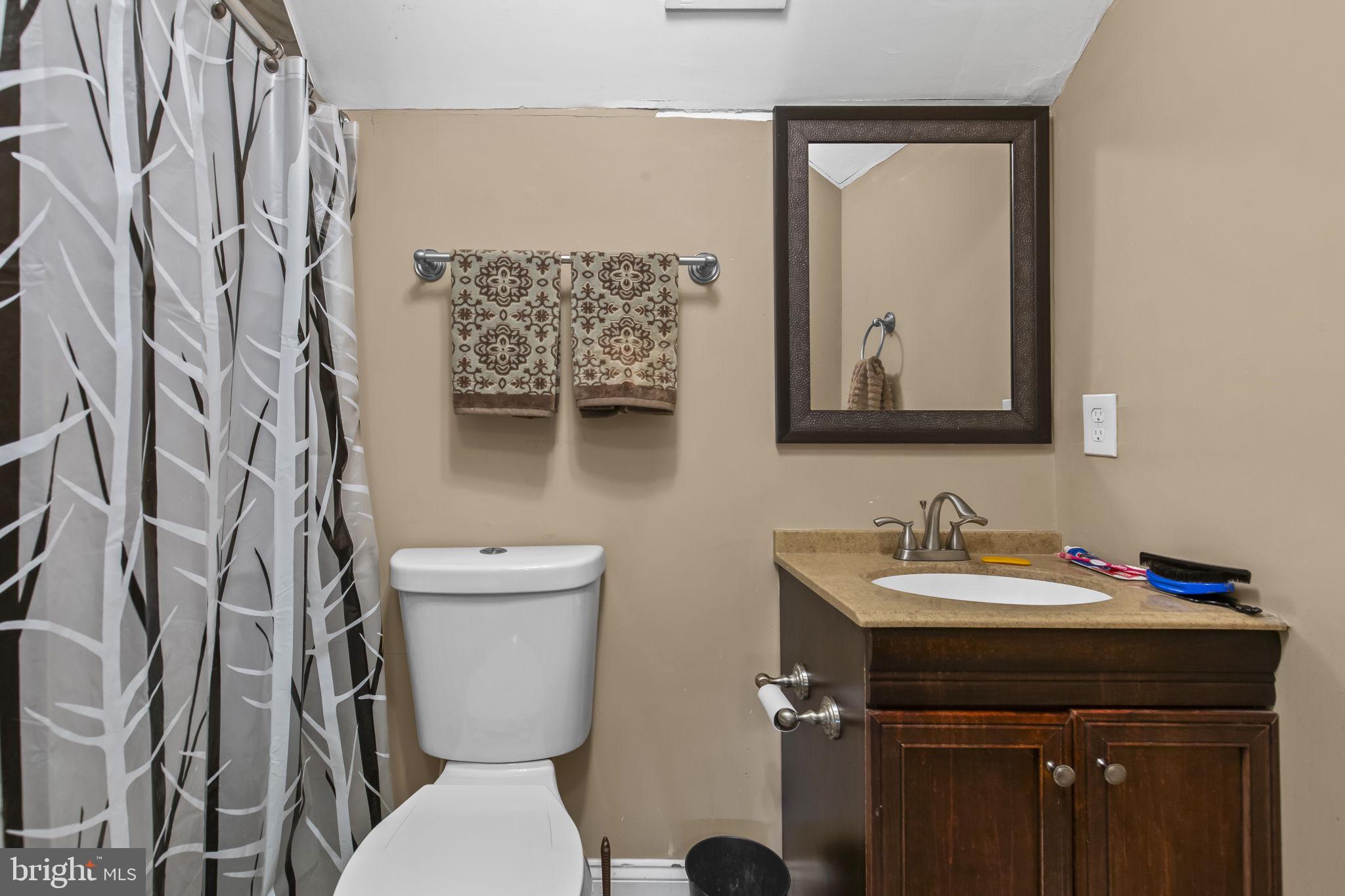 2600 Queen Anne Road Baltimore, MD 21216 - Photo 18 of 29 a bathroom with a toilet sink and mirror