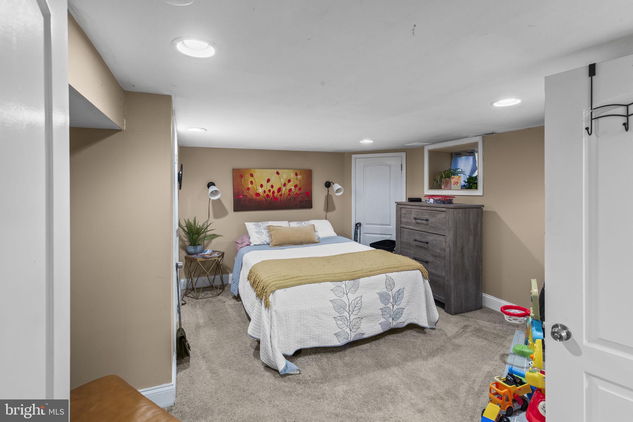 2600 Queen Anne Road Baltimore, MD 21216 - Photo 22 of 29 a bedroom with a bed and a dresser
