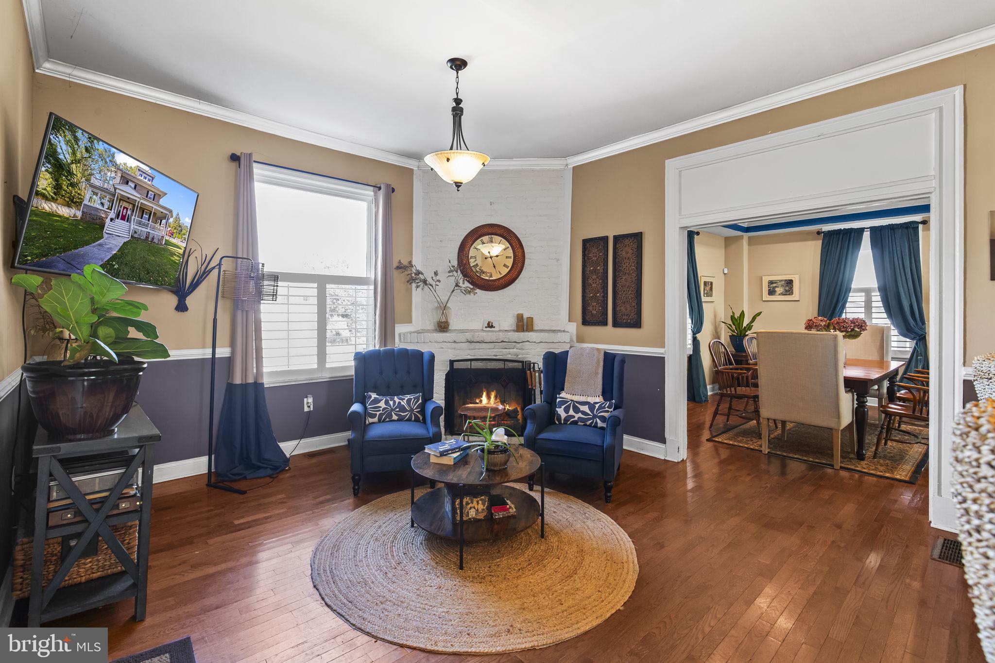 2600 Queen Anne Road Baltimore, MD 21216 - Photo 4 of 29 a living room with furniture a fireplace and a flat screen tv