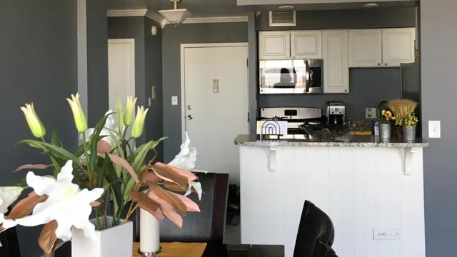 a kitchen with stainless steel appliances a refrigerator a sink a stove top oven a counter space and cabinets