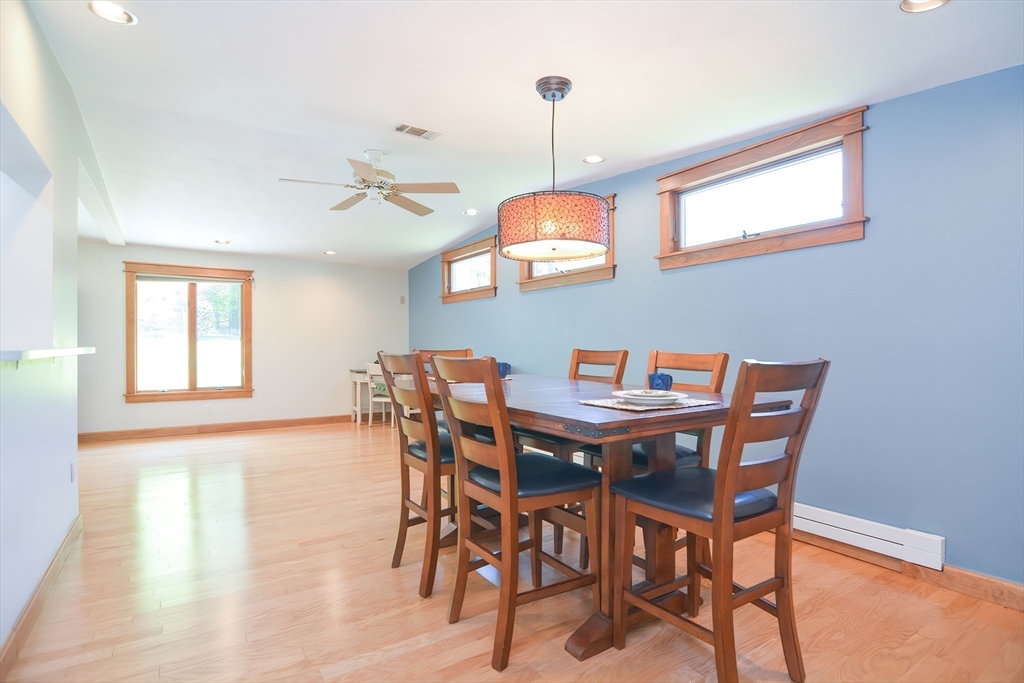 19 Daniels Road Framingham, MA 01701 - Photo 23 of 40 a view of a dining room and livingroom with furniture wooden floor a rug a painting and a chandelier