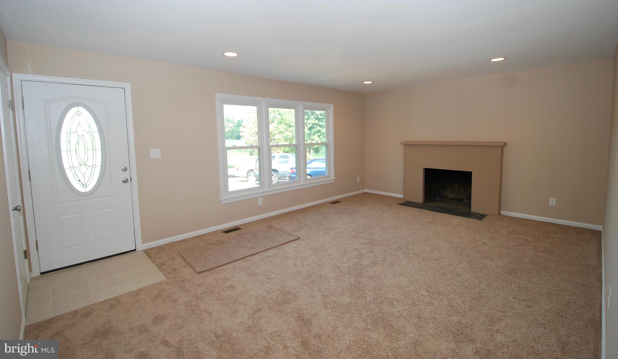 23501 Slidell Road Boyds, MD 20841 - Photo 3 of 27 an empty room with windows and wooden floor