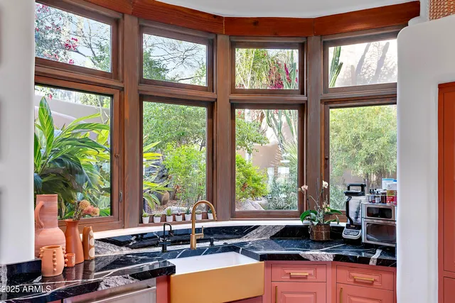a kitchen with granite countertop a large window and a counter space