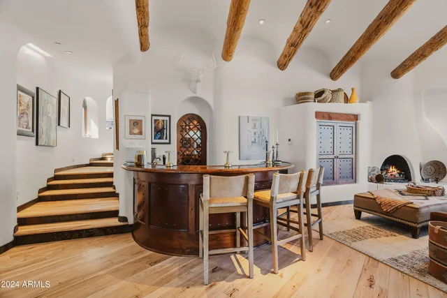 a living room with furniture a chandelier and a dining table