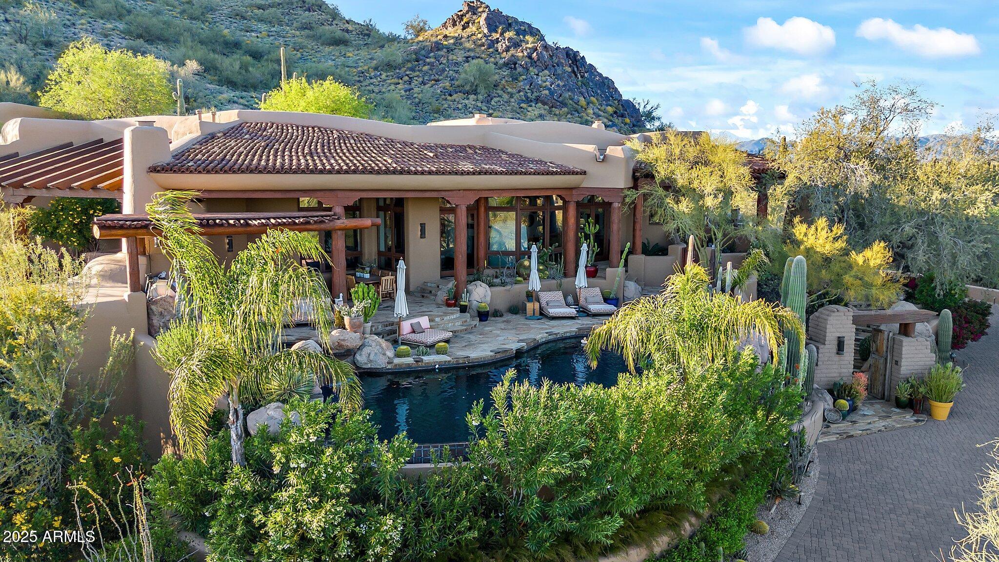 8300 East Dixileta Drive, Unit 263 Scottsdale, AZ 85266 - Photo 3 of 53 a view of a house with patio and garden