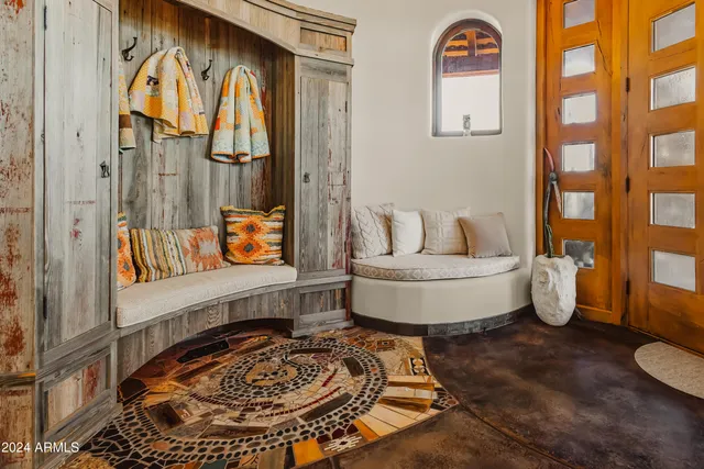 a living room with furniture and a painting on the wall