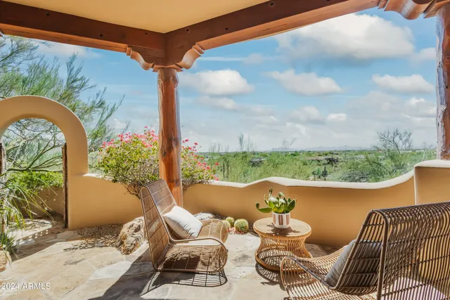 a view of a roof deck with couches and sky view