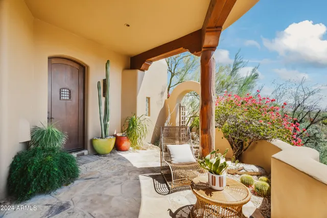 a view of a building with a yard and sitting area