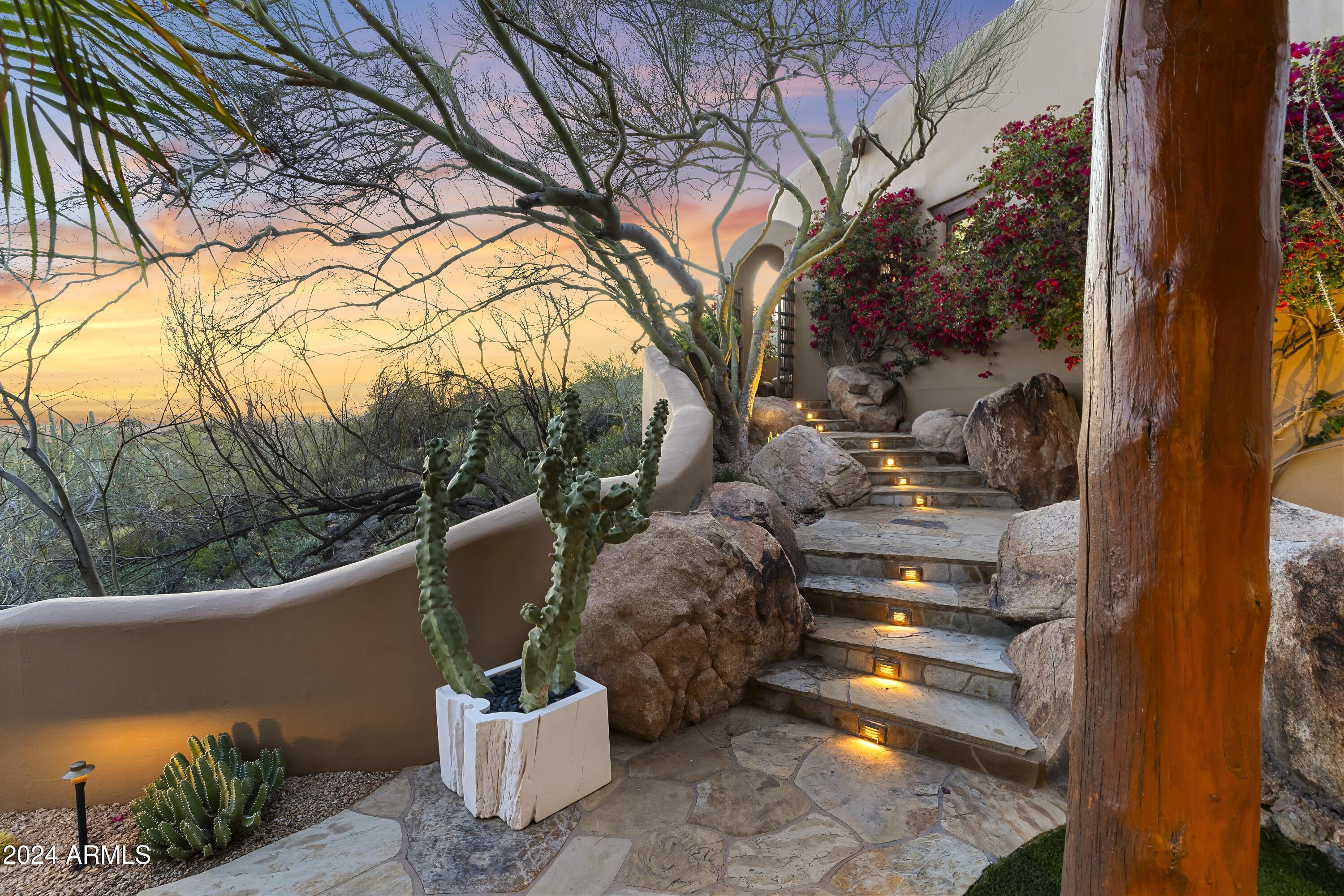 8300 East Dixileta Drive, Unit 263 Scottsdale, AZ 85266 - Photo 49 of 53 a view of a building with a yard and sitting area