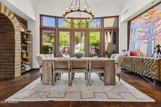 a living room with furniture a table and a large window