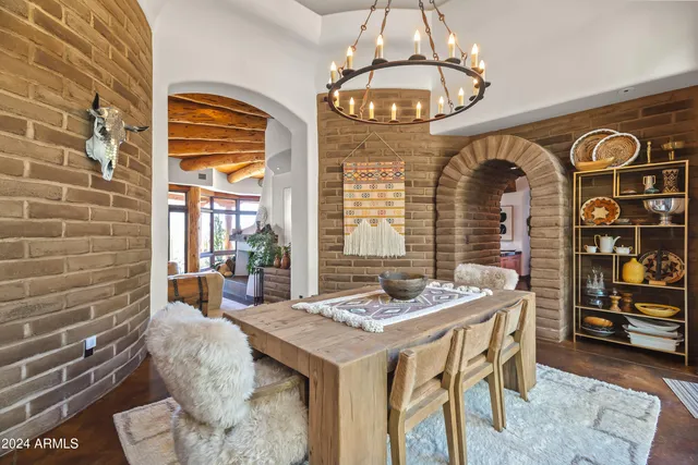 a view of a dining room with furniture and chandelier