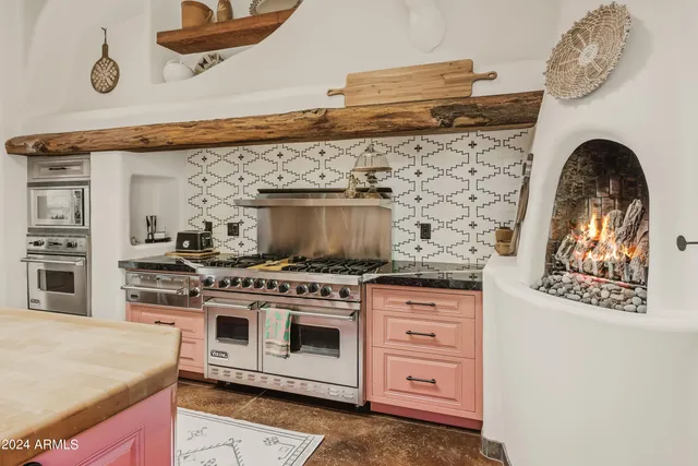 a white stove top oven sitting inside of a kitchen