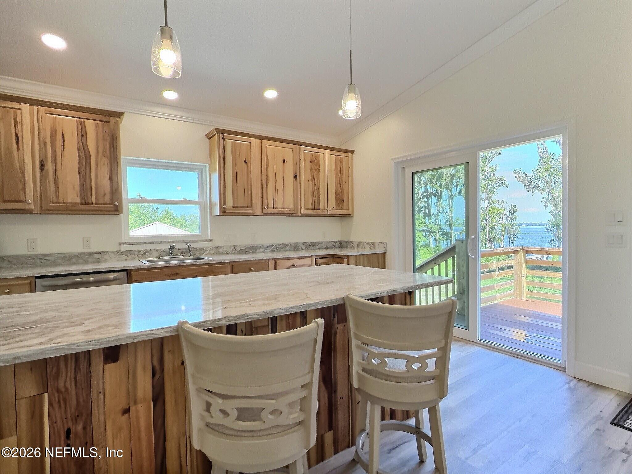 159 Mays Cove Road East Palatka, FL 32131 - Photo 45 of 62 a kitchen with kitchen island granite countertop wooden cabinets and a granite counter tops
