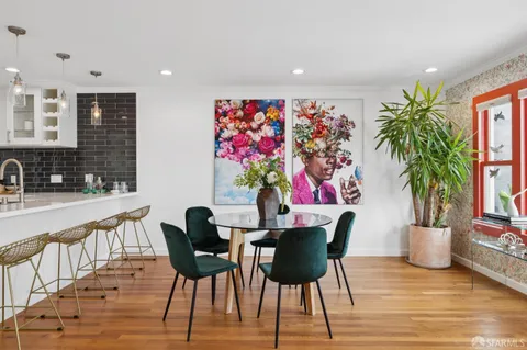 a view of a dining room with furniture and wooden floor