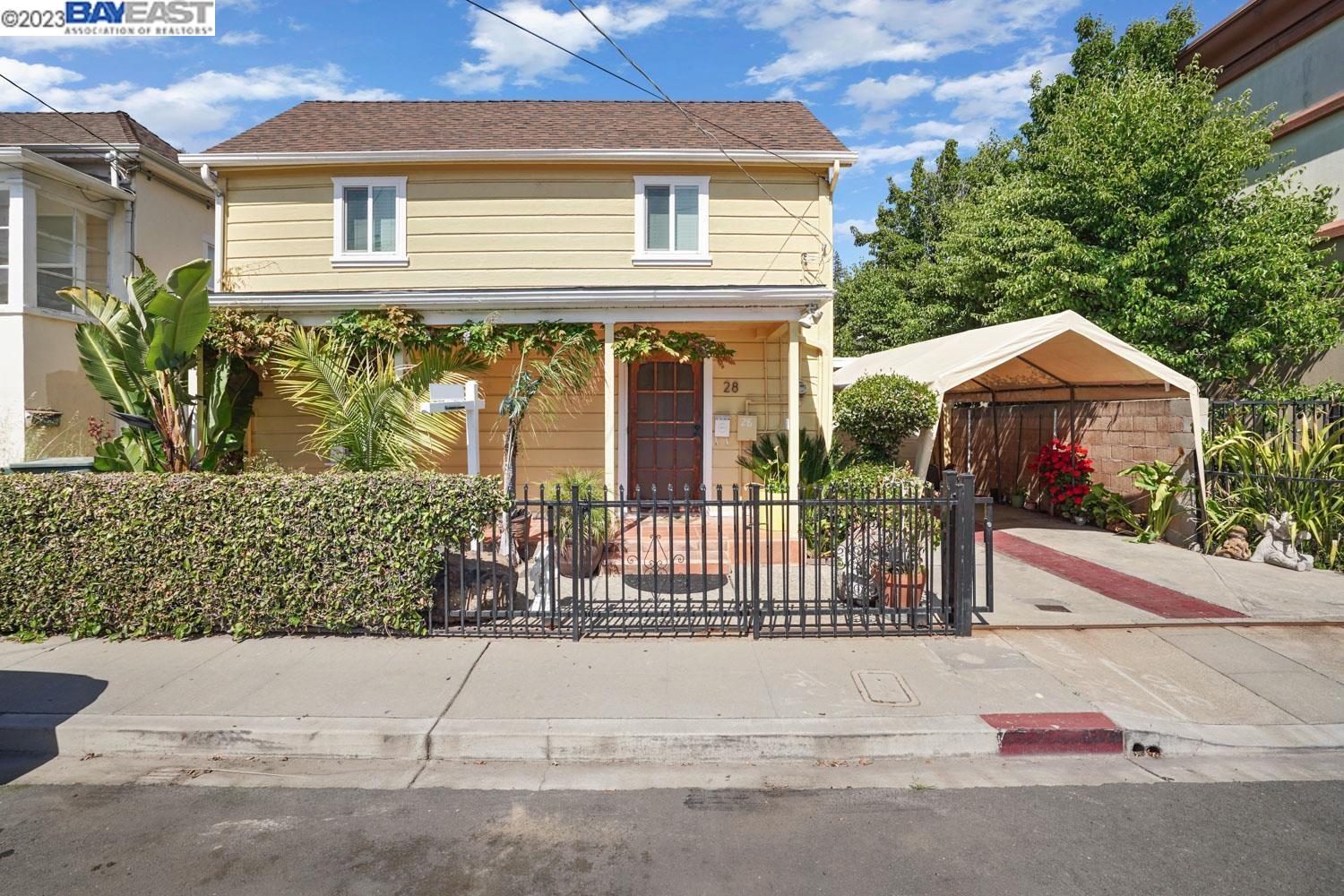 a front view of a house with a garden