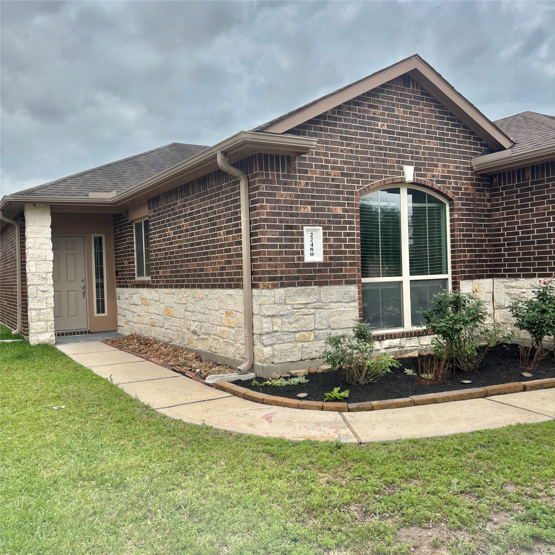 22480 Toronado Ridge Lane Porter, TX 77365 - Photo 2 of 42 a front view of a house with a yard and garage