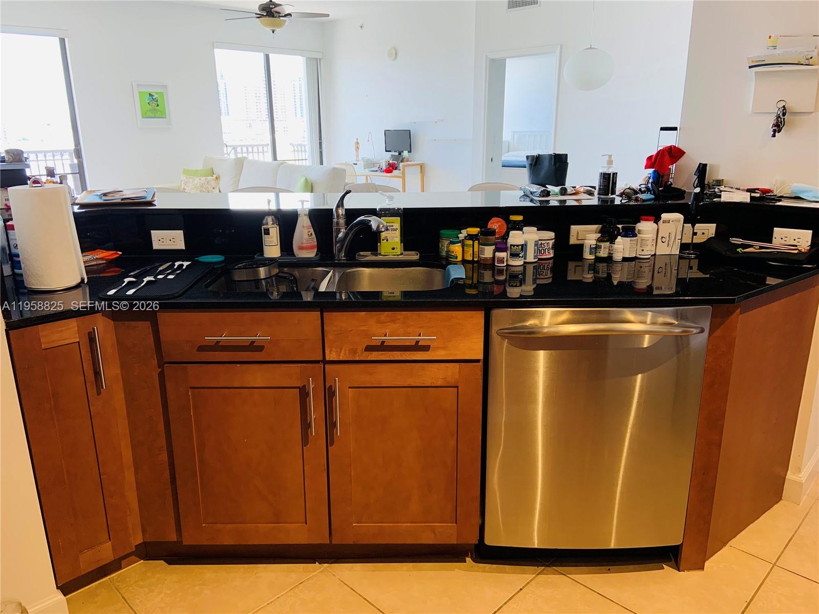 8395 Southwest 73rd Avenue, Unit 704 Miami, FL 33143 - Photo 11 of 47 a kitchen with stainless steel appliances granite countertop a sink and cabinets