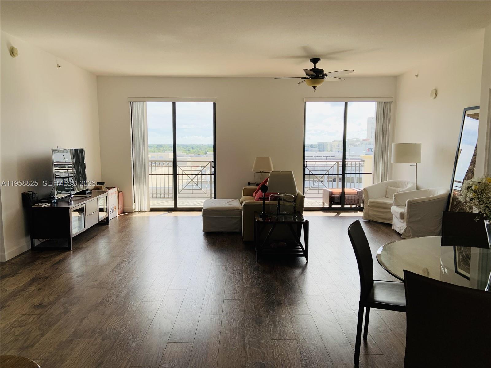 8395 Southwest 73rd Avenue, Unit 704 Miami, FL 33143 - Photo 12 of 47 a living room with furniture and a large window