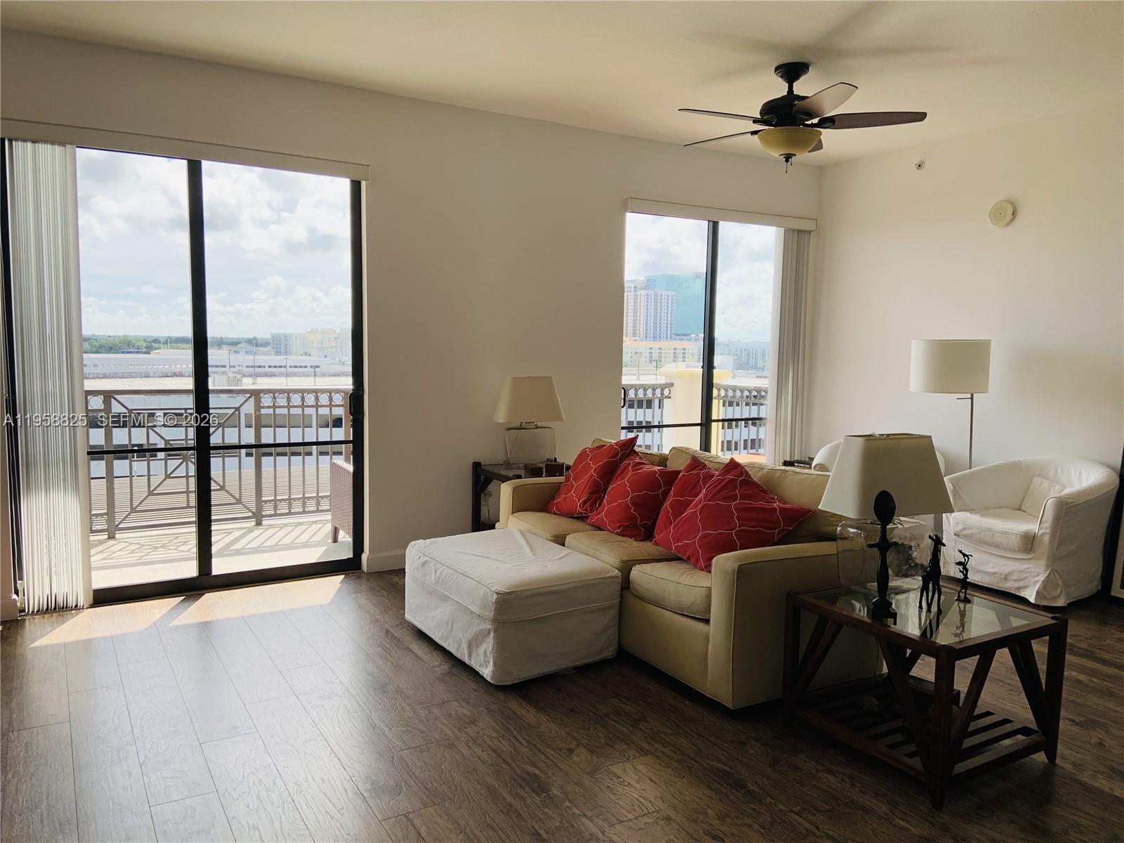 8395 Southwest 73rd Avenue, Unit 704 Miami, FL 33143 - Photo 13 of 47 a living room with furniture and a large window