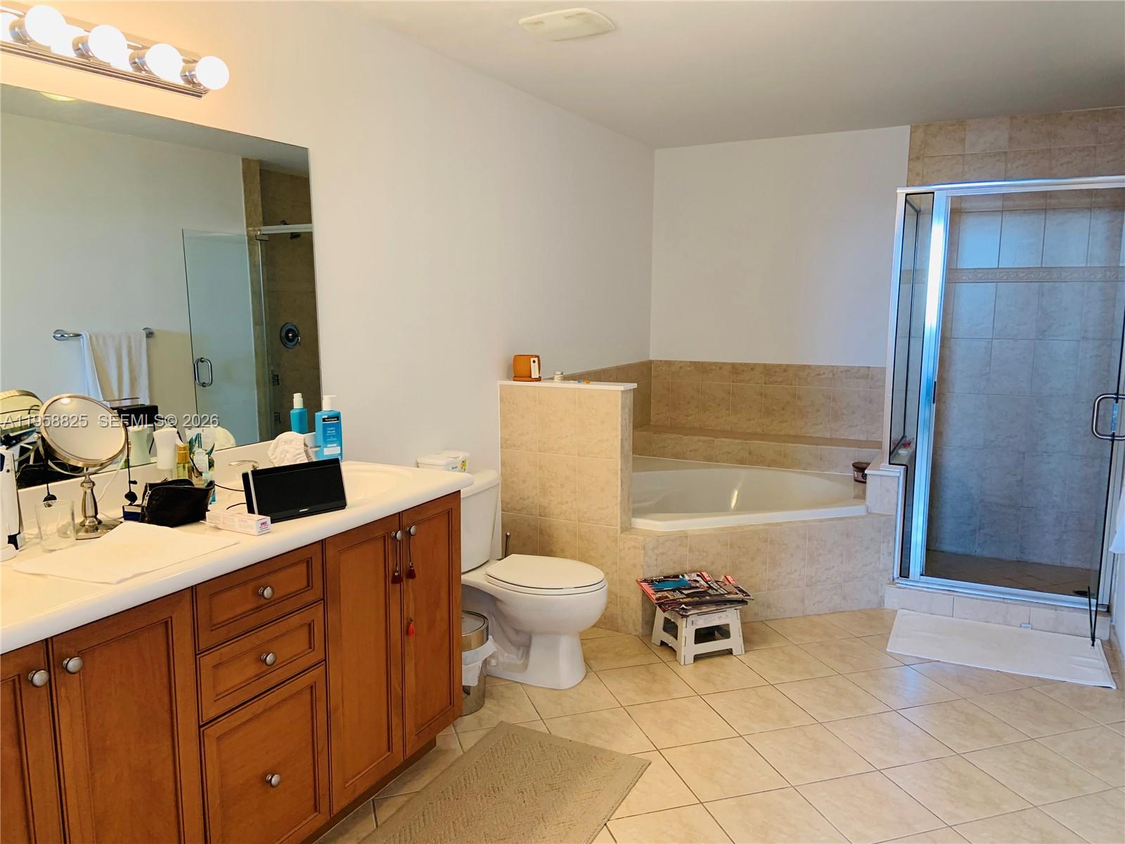 8395 Southwest 73rd Avenue, Unit 704 Miami, FL 33143 - Photo 22 of 47 a bathroom with a sink a toilet and shower