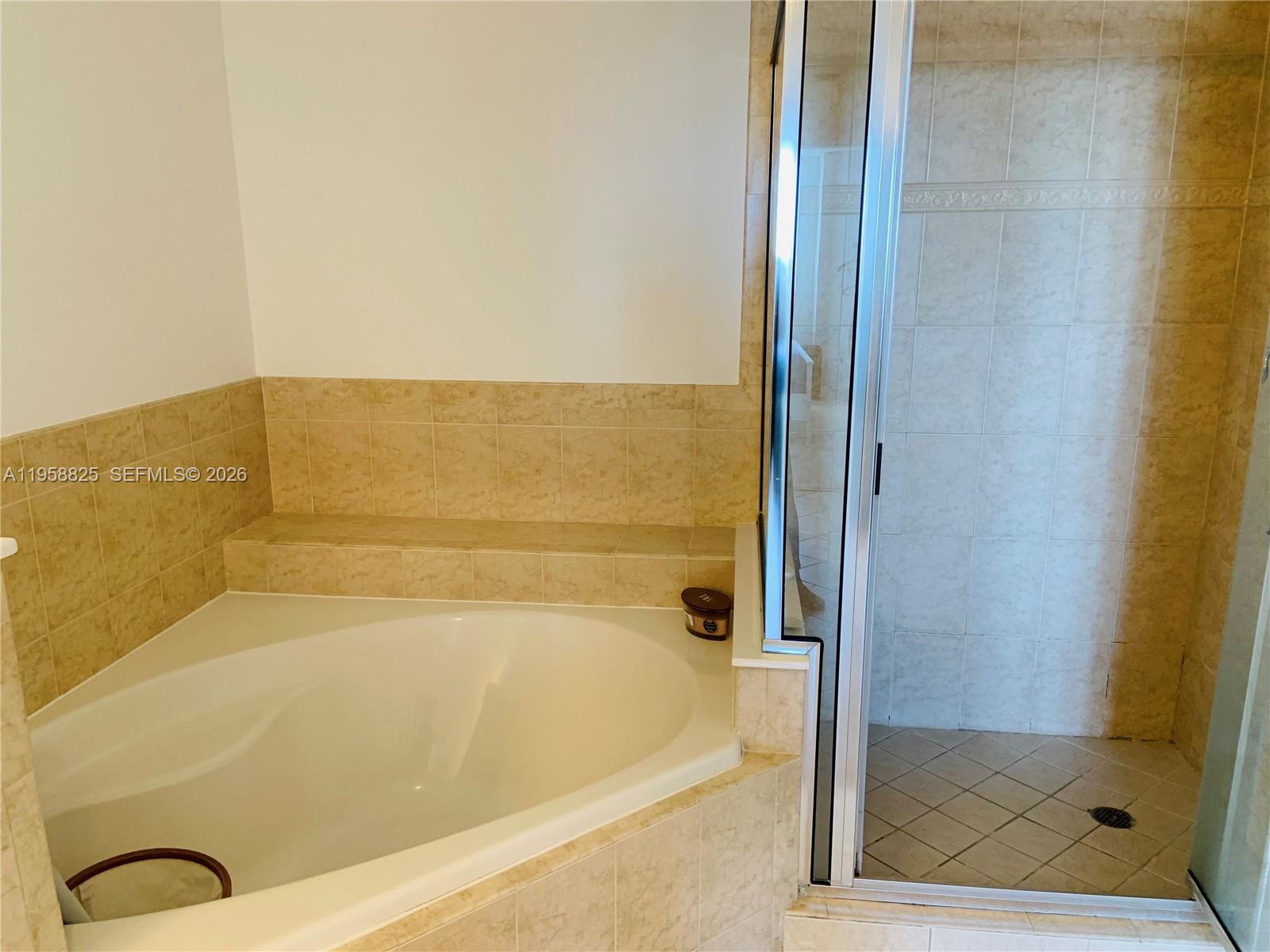 8395 Southwest 73rd Avenue, Unit 704 Miami, FL 33143 - Photo 23 of 47 a bathroom with a bathtub and shower