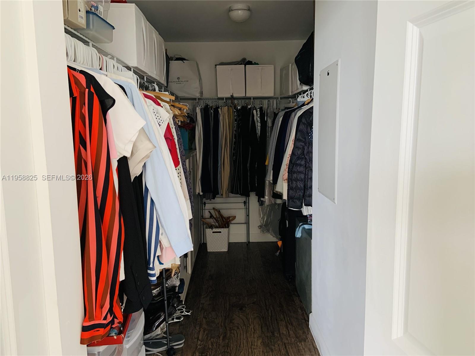 8395 Southwest 73rd Avenue, Unit 704 Miami, FL 33143 - Photo 24 of 47 a view of walk in closet with clothes and shoes
