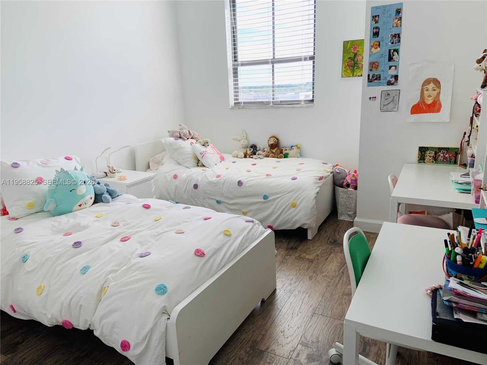 8395 Southwest 73rd Avenue, Unit 704 Miami, FL 33143 - Photo 26 of 47 a utility room with bed and wooden floor