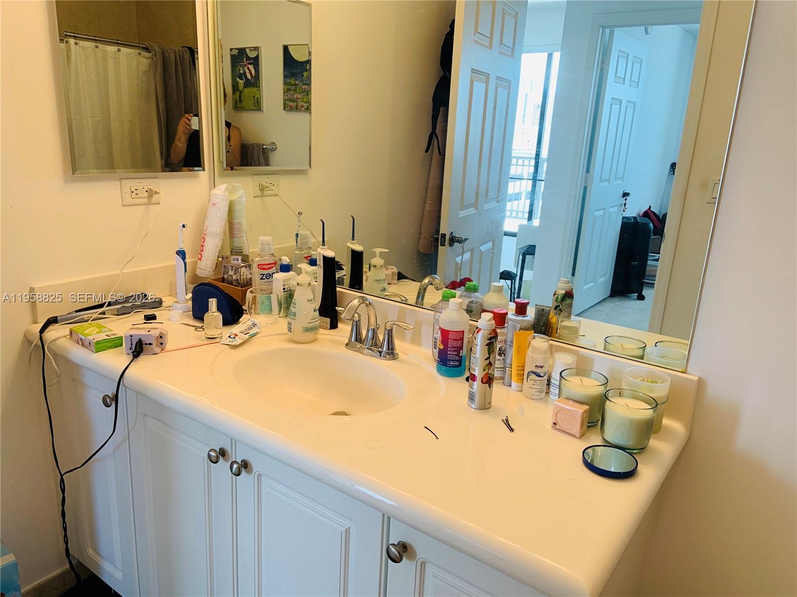 8395 Southwest 73rd Avenue, Unit 704 Miami, FL 33143 - Photo 27 of 47 a bathroom with a sink and a mirror