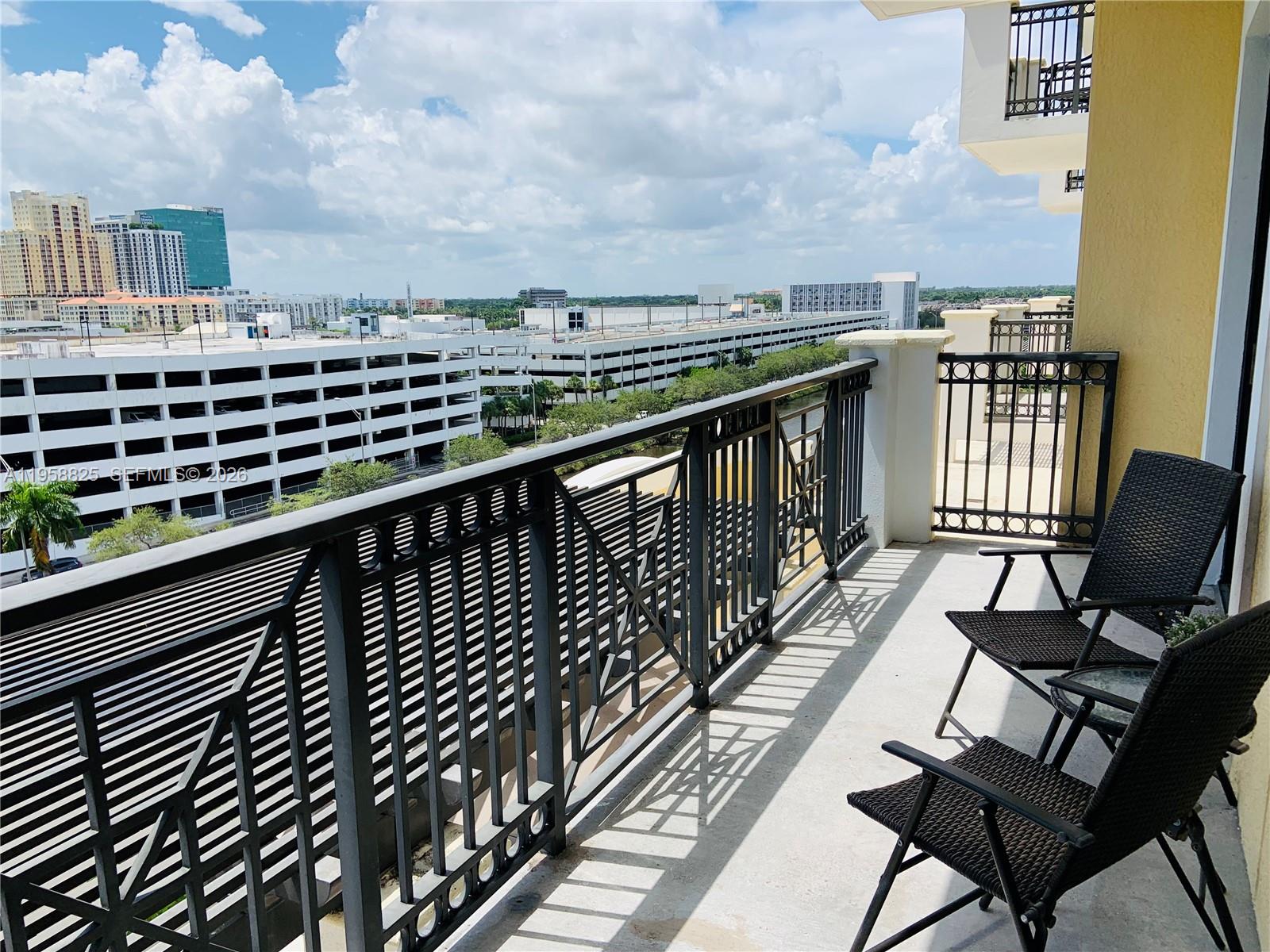 8395 Southwest 73rd Avenue, Unit 704 Miami, FL 33143 - Photo 33 of 47 a view of a balcony with wooden chairs