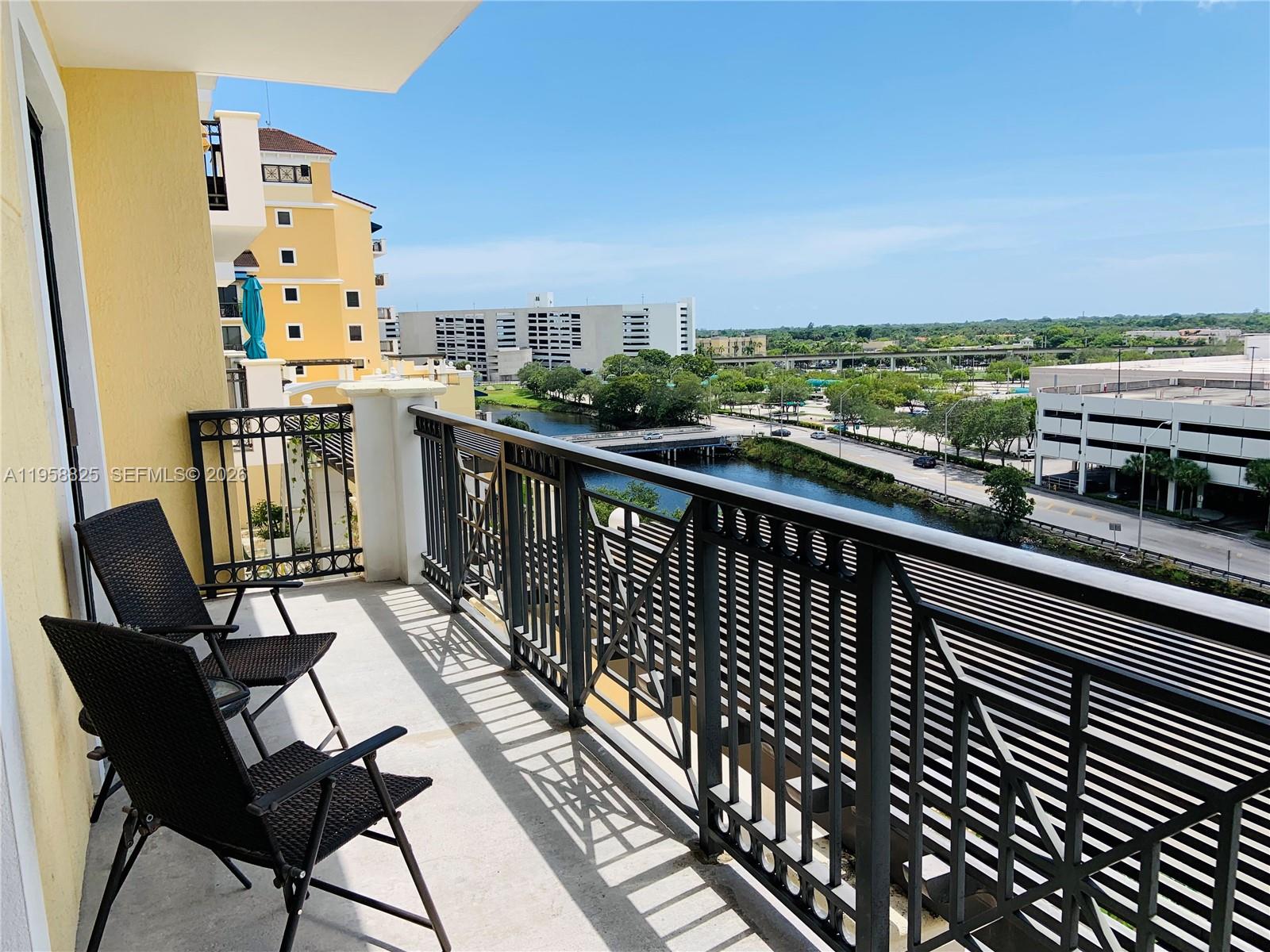 8395 Southwest 73rd Avenue, Unit 704 Miami, FL 33143 - Photo 35 of 47 a view of balcony with wooden floor and seating space
