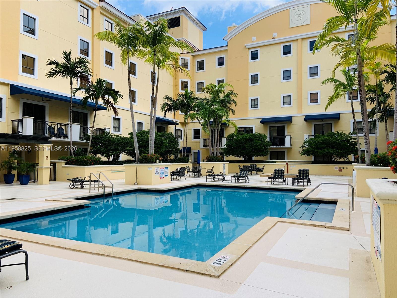 8395 Southwest 73rd Avenue, Unit 704 Miami, FL 33143 - Photo 40 of 47 a view of a swimming pool with outdoor seating