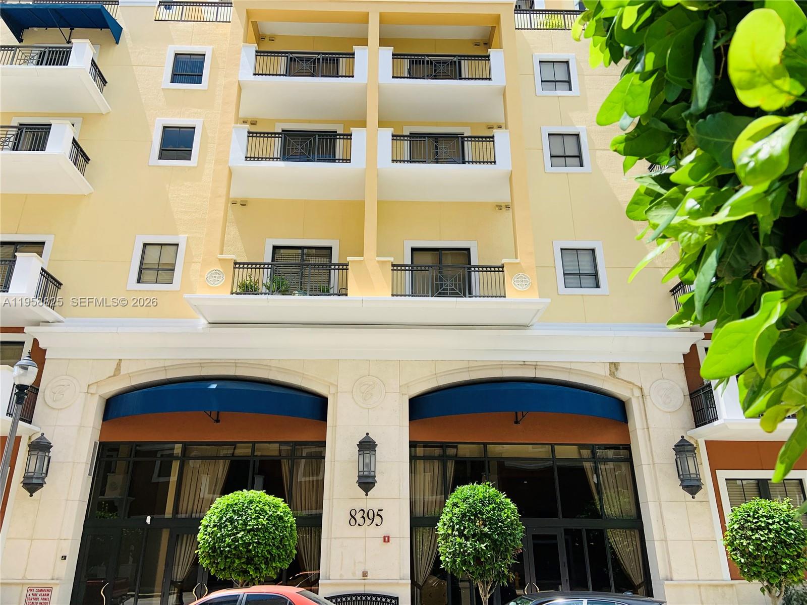 8395 Southwest 73rd Avenue, Unit 704 Miami, FL 33143 - Photo 47 of 47 a front view of a building with a garden