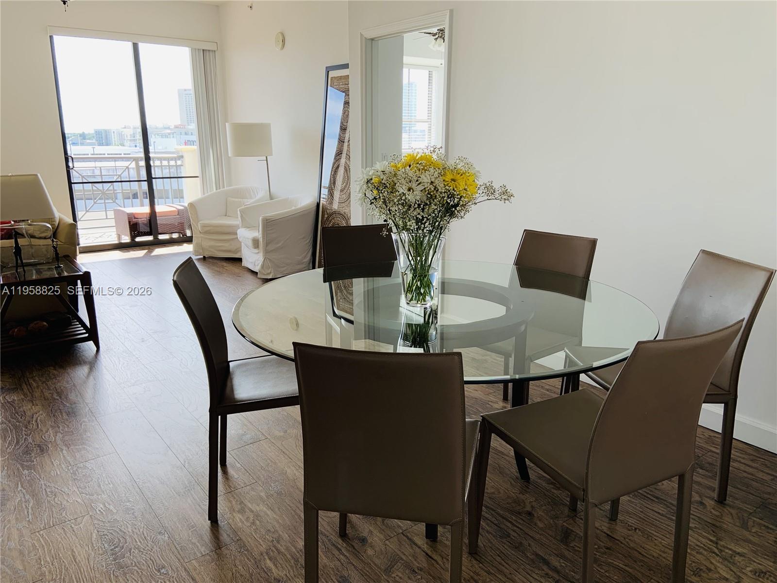 8395 Southwest 73rd Avenue, Unit 704 Miami, FL 33143 - Photo 6 of 47 a view of a dining room with furniture and wooden floor