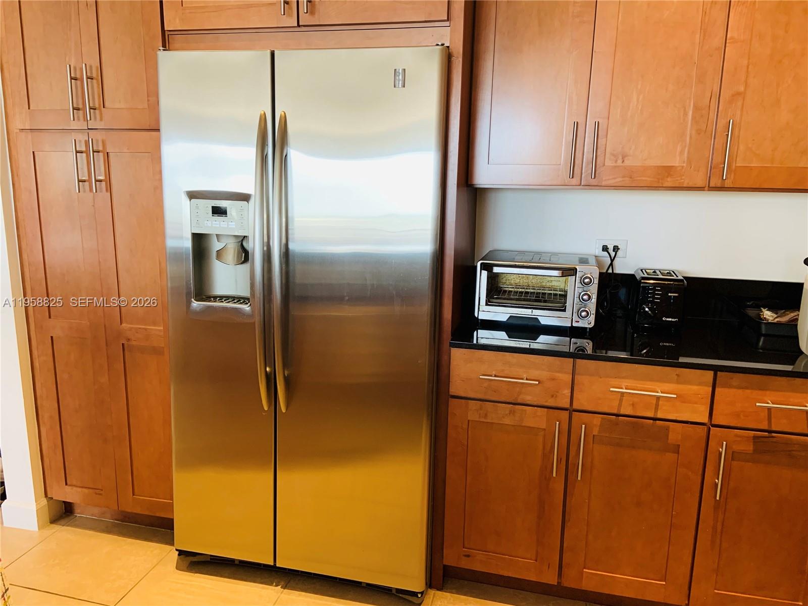 8395 Southwest 73rd Avenue, Unit 704 Miami, FL 33143 - Photo 8 of 47 a kitchen with metallic refrigerator freezer and a dishwasher