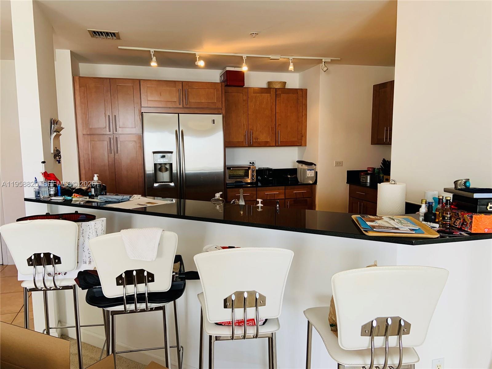 8395 Southwest 73rd Avenue, Unit 704 Miami, FL 33143 - Photo 10 of 47 a kitchen with a table and chairs in it