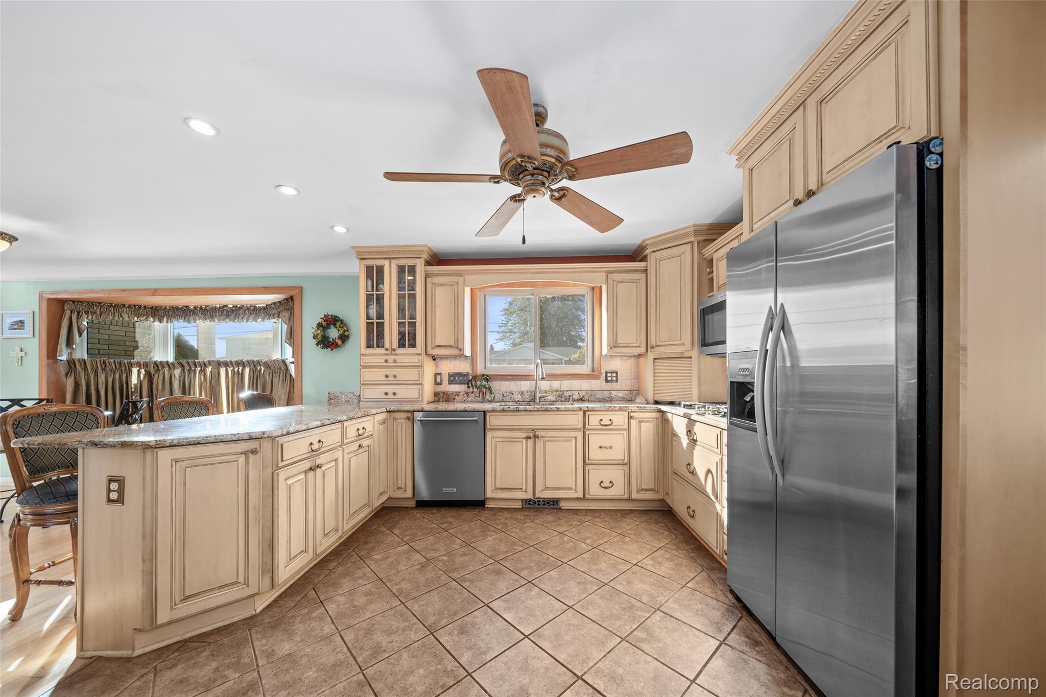 7214 Cardinal Road Algonac, MI 48001 - Photo 21 of 51 Kitchen featuring glass insert cabinets, stainless steel appliances, a peninsula, recessed lighting, and a ceiling fan