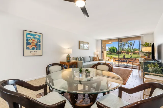 a view of a dining room with furniture and a potted plant