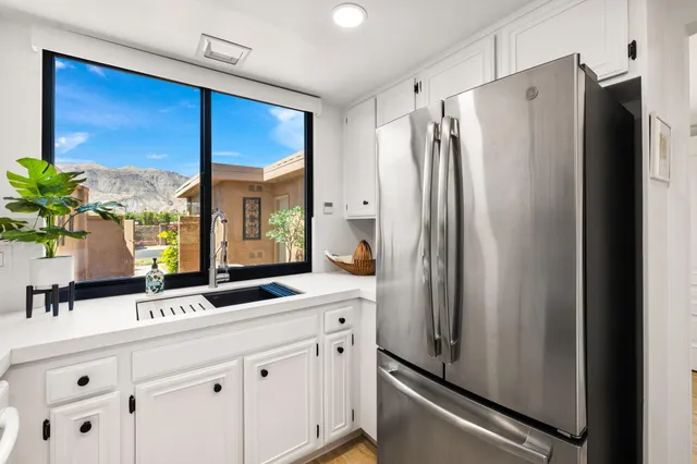 a kitchen with stainless steel appliances a refrigerator and a sink