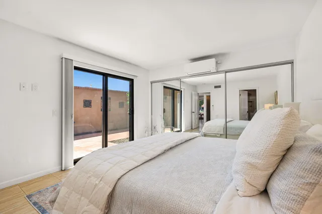 a bedroom with a large bed and a large window