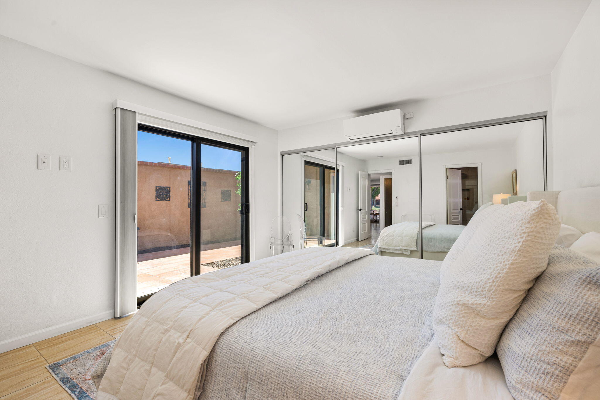 56 Majorca Drive Rancho Mirage, CA 92270 - Photo 22 of 33 a bedroom with a large bed and a large window