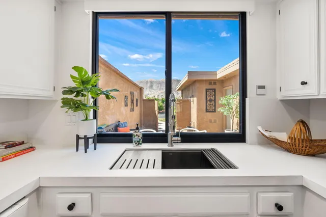 a kitchen view of a kitchen counter top a stove and a wooden floor