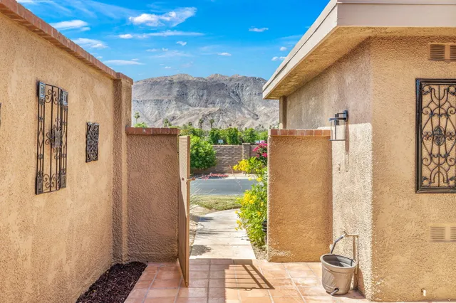 a view of a back yard from a corridor