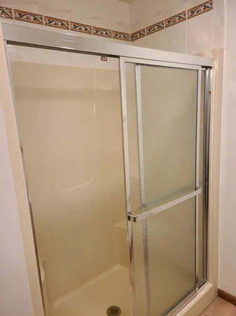 a bathroom with a glass shower door