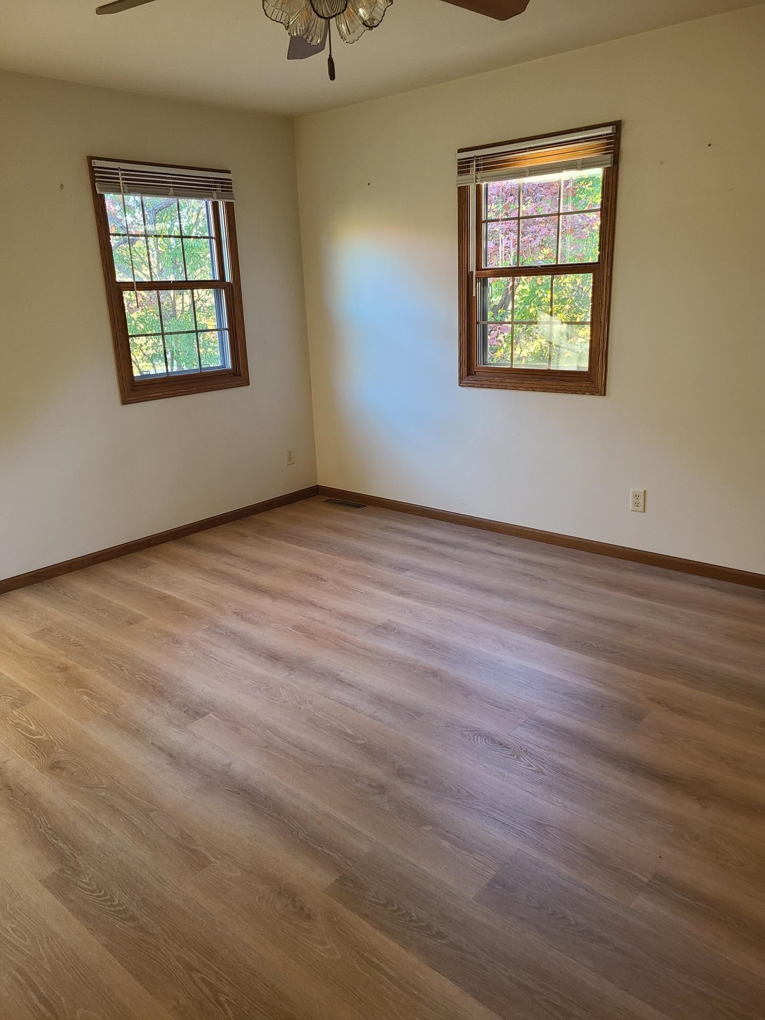 2871 East 777th Road Utica, IL 61373 - Photo 19 of 23 an empty room with wooden floor and windows