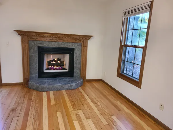a view of an empty room and wooden floor