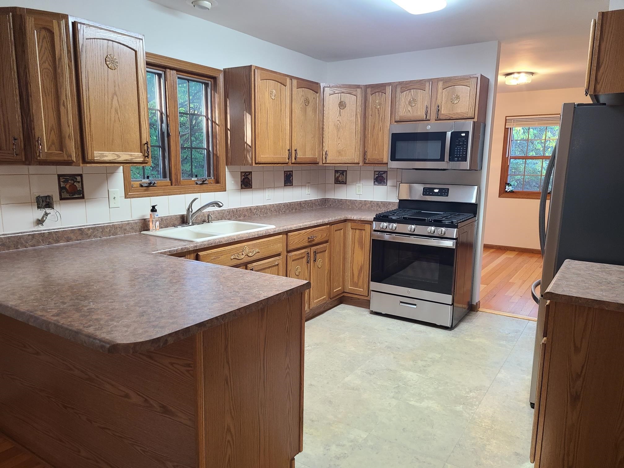 2871 East 777th Road Utica, IL 61373 - Photo 4 of 23 a kitchen with stainless steel appliances granite countertop a sink stove microwave and refrigerator